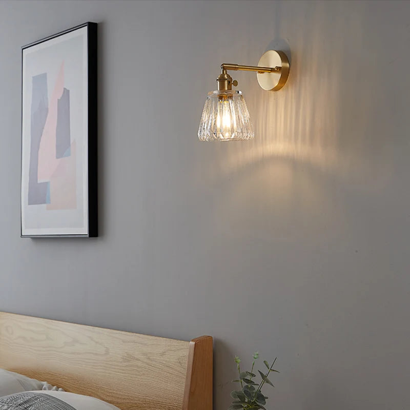 Kyoto brass and glass wall lamp mounted beside a bathroom mirror casting warm light