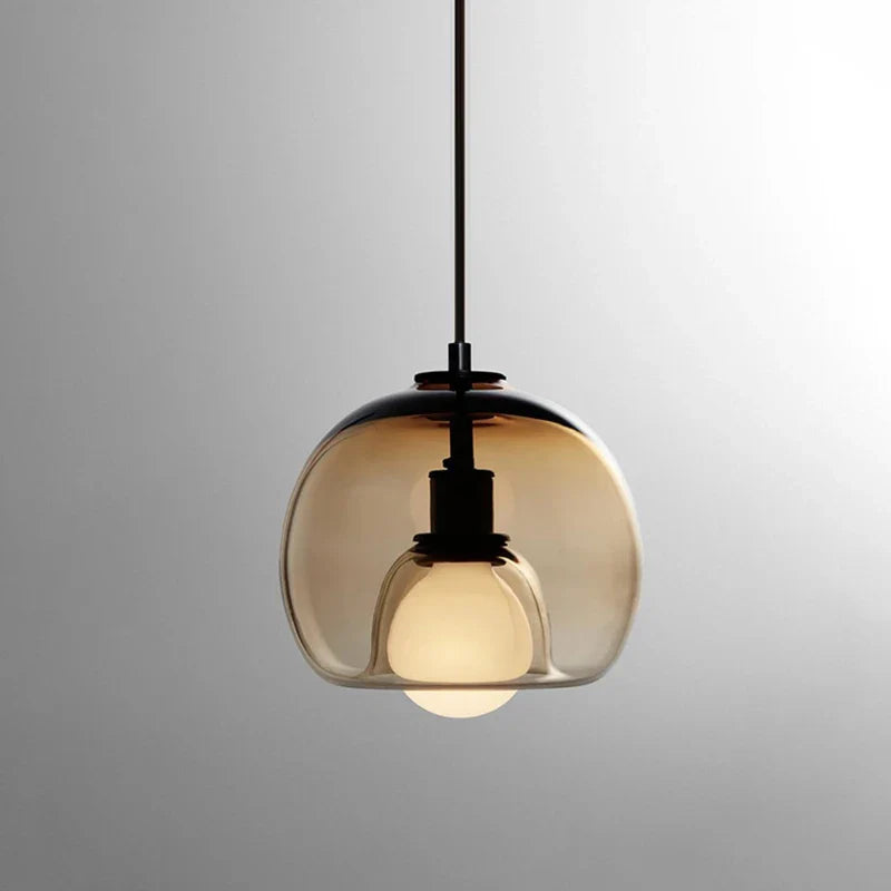 Anele smoke grey dome glass pendant light in a row of three above a kitchen island