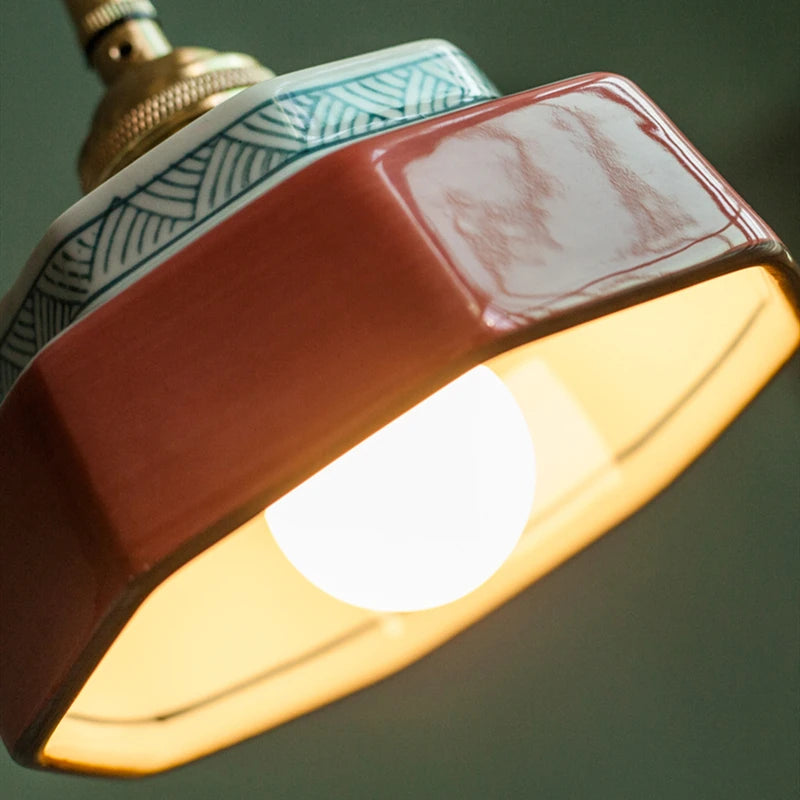 Kensington hand-painted red ceramic pendant light with copper fitting in a dining room