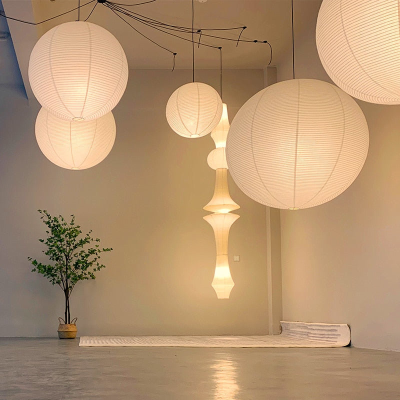 Linnea natural rattan pendant light hanging above a wooden dining table in a Nordic interior