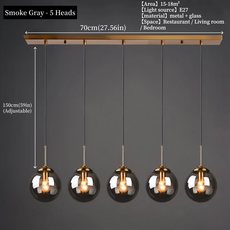 Orla amber glass and metal pendant light hanging above a bedside table in a Nordic-style bedroom