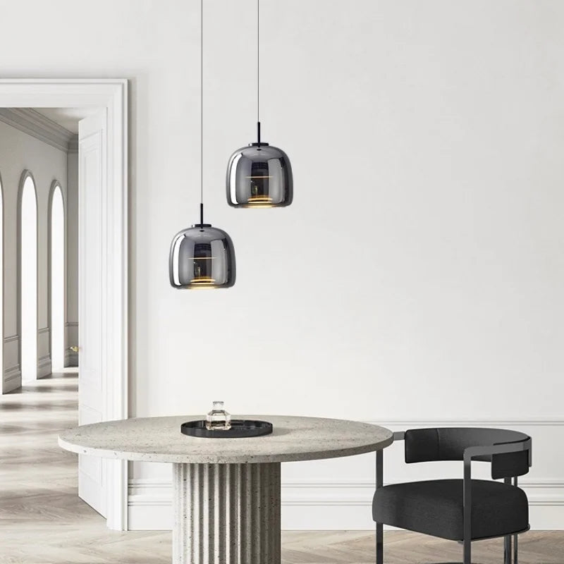 Astrid amber glass Nordic pendant light with gold fitting above a dining table