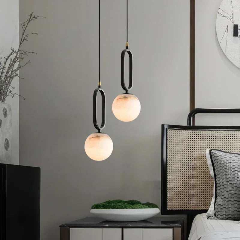 Hulda natural marble pendant light with copper accents above a formal dining table