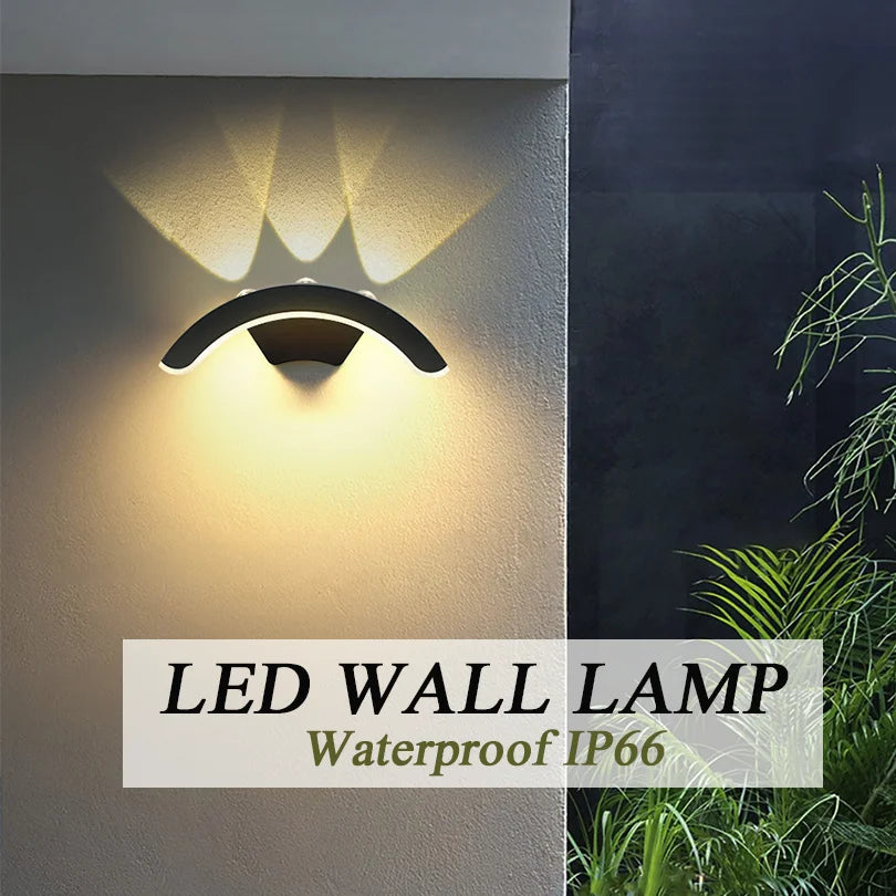 Hadley IP66 weatherproof outdoor wall lantern in black, mounted on a rendered exterior wall
