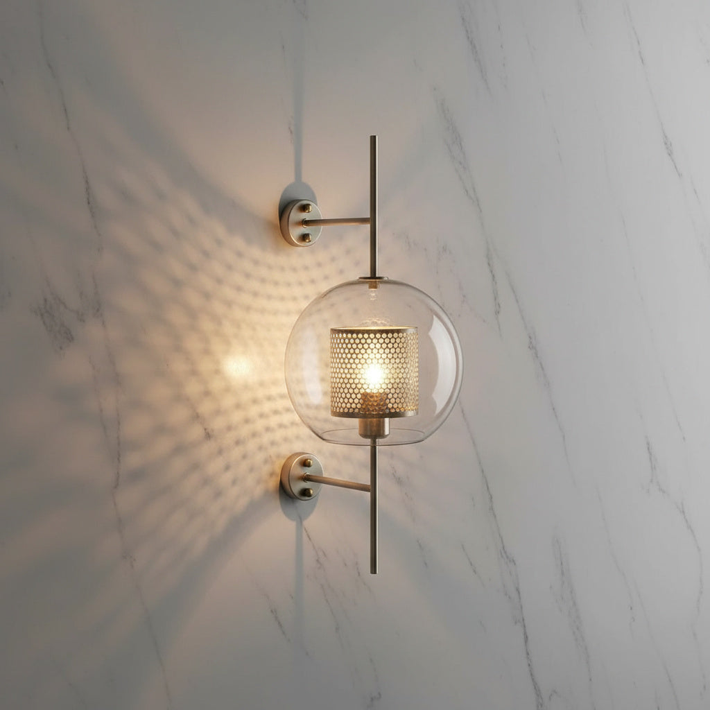 Alegria gold glass wall sconce flanking a bathroom mirror, casting warm light