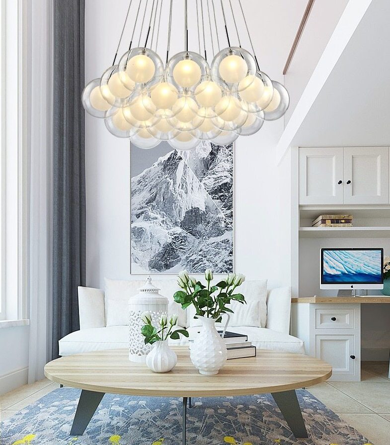 Cluster glass ball chandelier with multiple white glass spheres hanging above a dining table