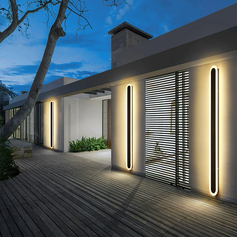 Cupola IP65 wrought iron outdoor wall light mounted on a rendered garden wall at dusk