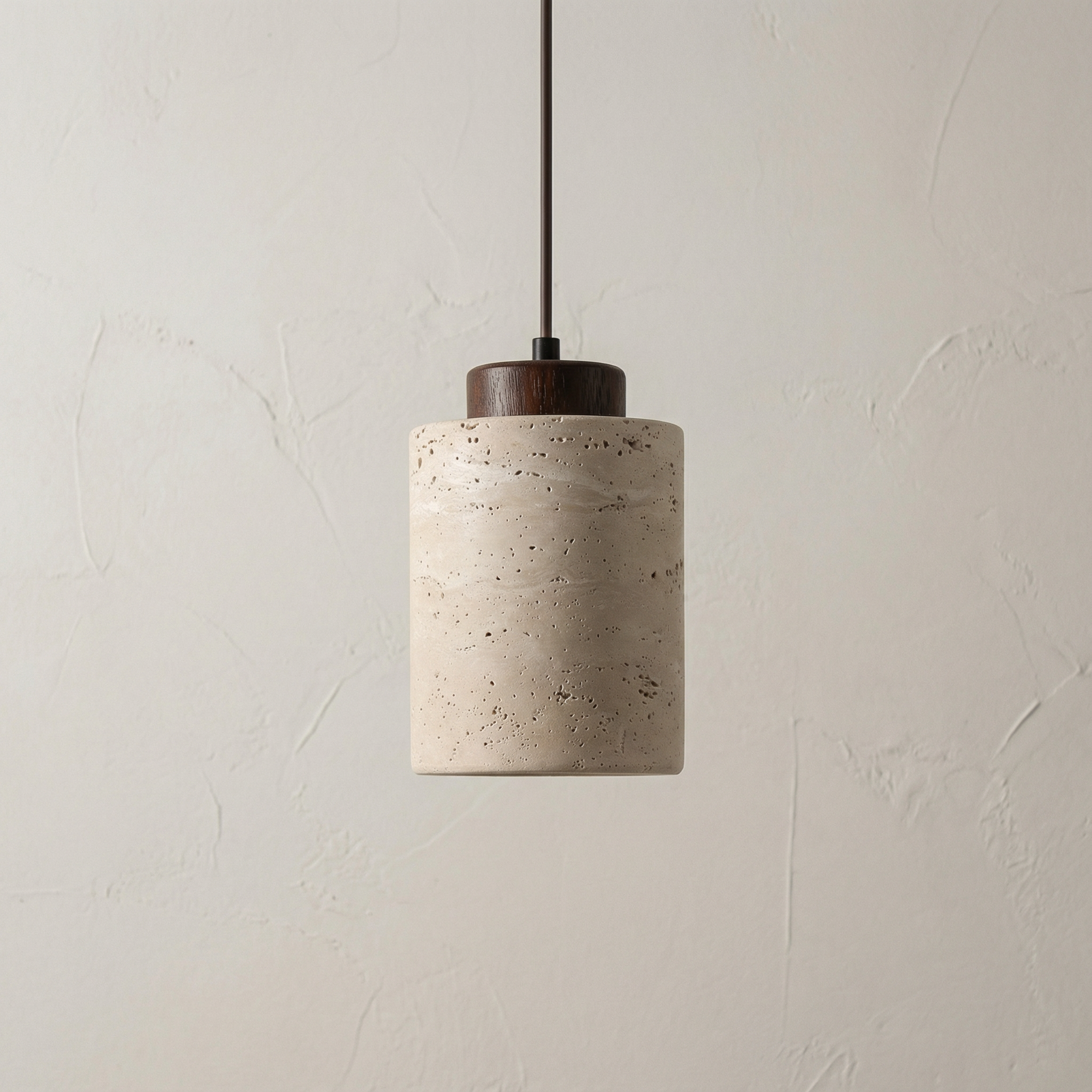 Vidar stone-effect sculptural pendant light in light finish above a dining table