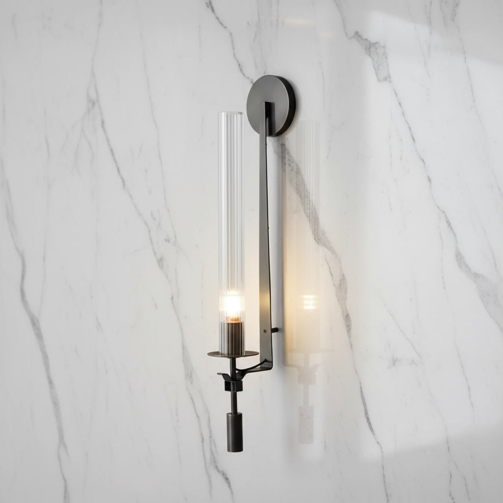 Dagny gold leaf wall sconce with glass element mounted flanking a bed