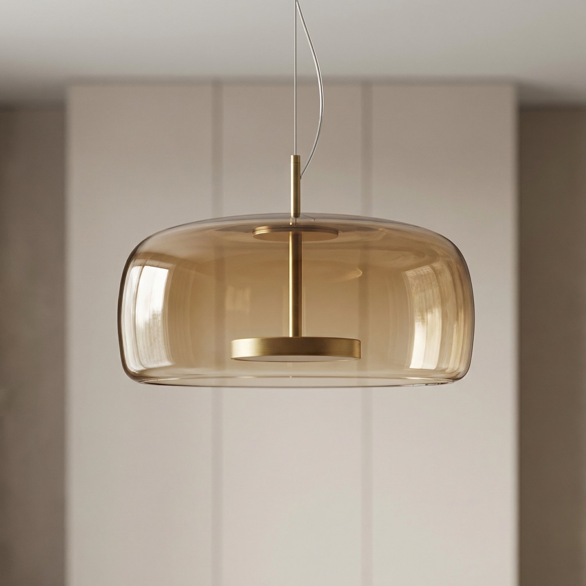 Astrid amber glass Nordic pendant light with gold fitting above a dining table