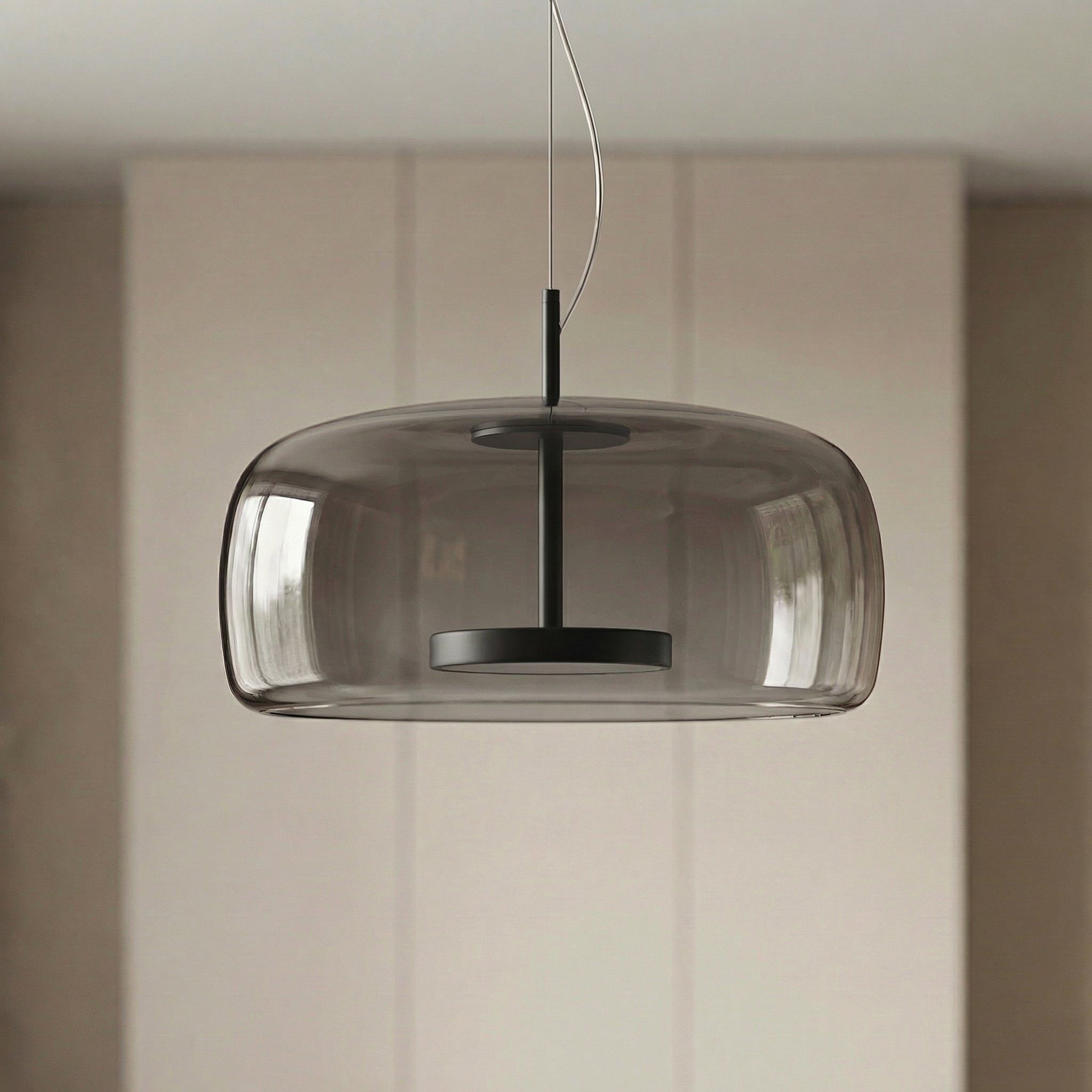 Astrid amber glass Nordic pendant light with gold fitting above a dining table