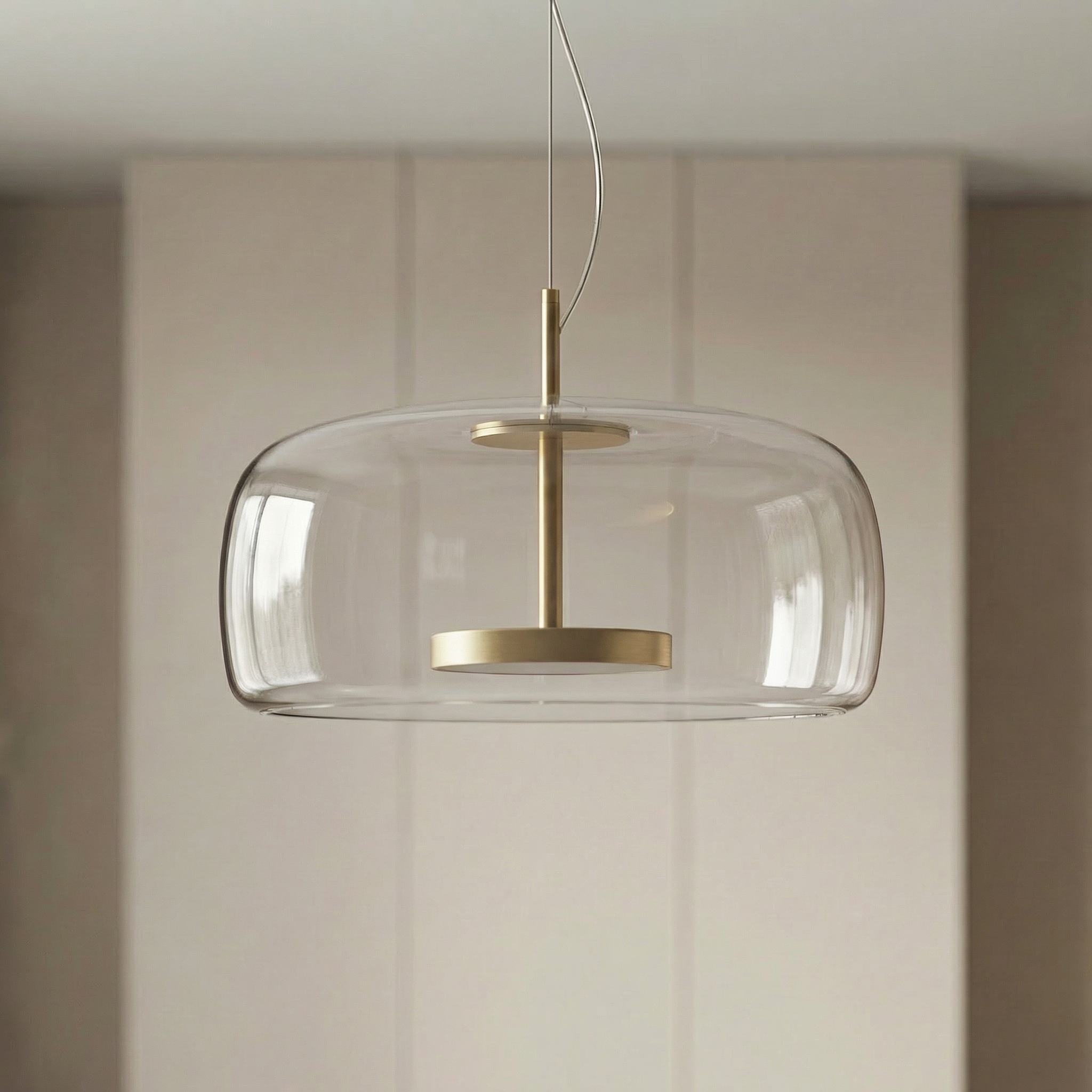Astrid amber glass Nordic pendant light with gold fitting above a dining table